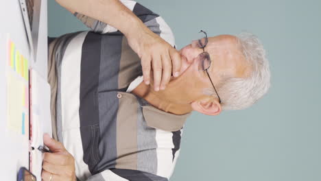 Vertical-video-of-The-man-who-fell-asleep-in-front-of-a-laptop.